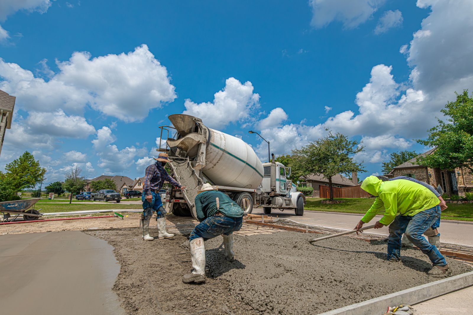 A crew pouring a concrete driveway together